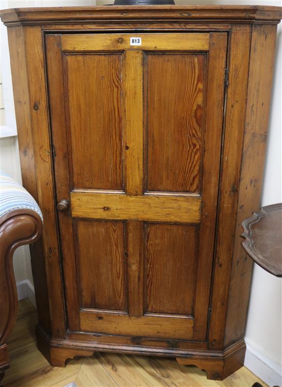 An early 19th century stripped pine corner cupboard, H.132cm